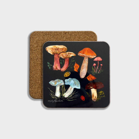 A square coaster with a dark background featuring a hand-painted illustration of colourful mushrooms, accompanied by a cork backing.