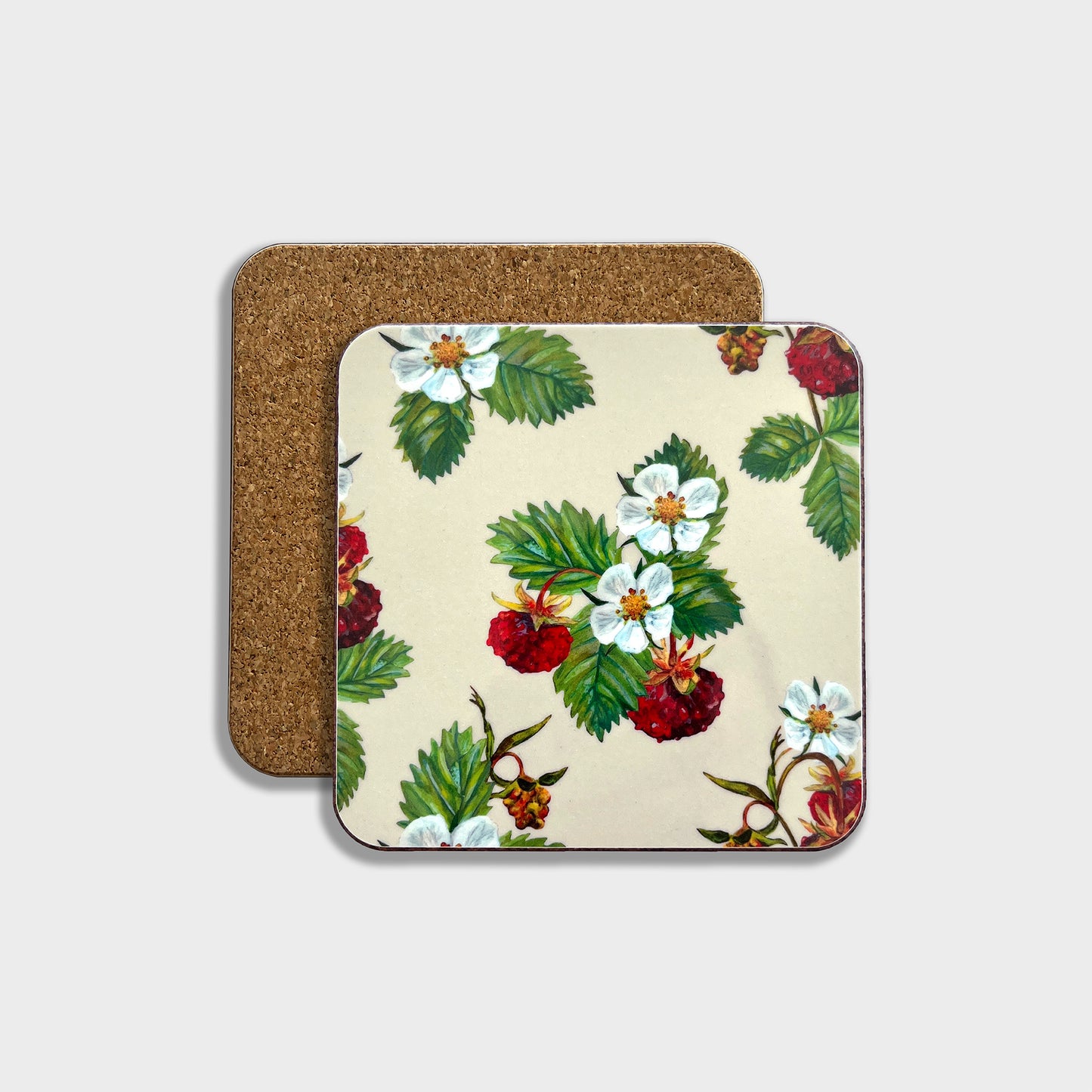 A square coaster with a hand illustrated wild strawberry design, featuring red strawberries and green leaves on a beige background, with a cork backing visible.