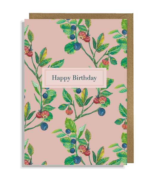 A Bilberry Happy Birthday card with hand painted illustrations of bilberry fruit, flowers and leaves on a pink background, with a Happy Birthday message.