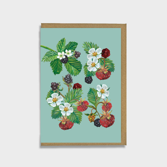 A greeting card with hand painted illustrations of wild strawberries and bramble berries on a blue green background, with a brown kraft envelope.