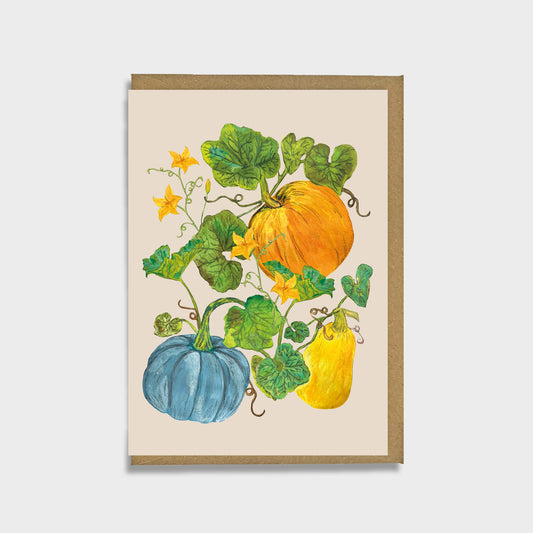 A greeting card with hand painted illustrations of pumpkins, squash and foliage on a cream colored background.