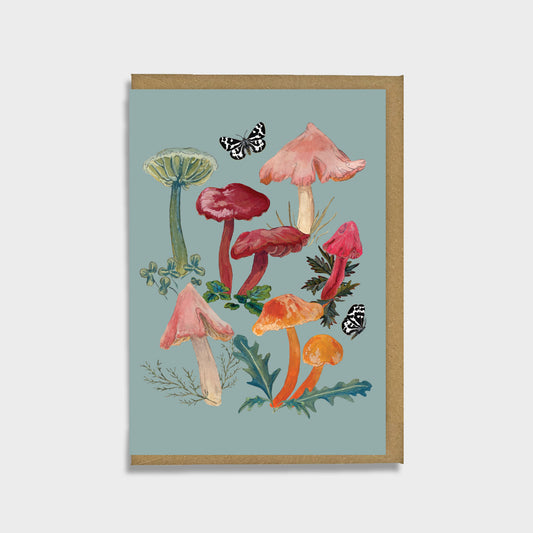 A greeting card featuring an illustration of various colorful waxcap mushrooms with moths, set against a muted background.