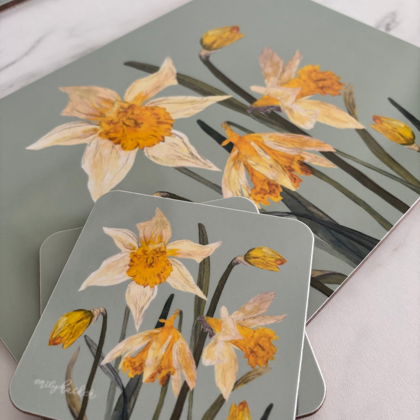 Set of coasters and placemat with daffodil floral design with light blue background