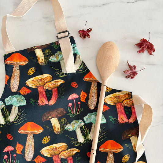 Cotton children’s apron with hand illustrated toadstool and mushroom design