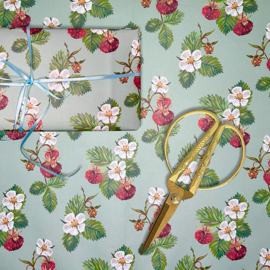 Wild Strawberry illustrated paper with a roll of tape and gold scissors on a matching background