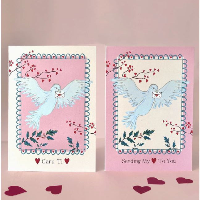 Two greeting cards with doves and floral designs on a pink background