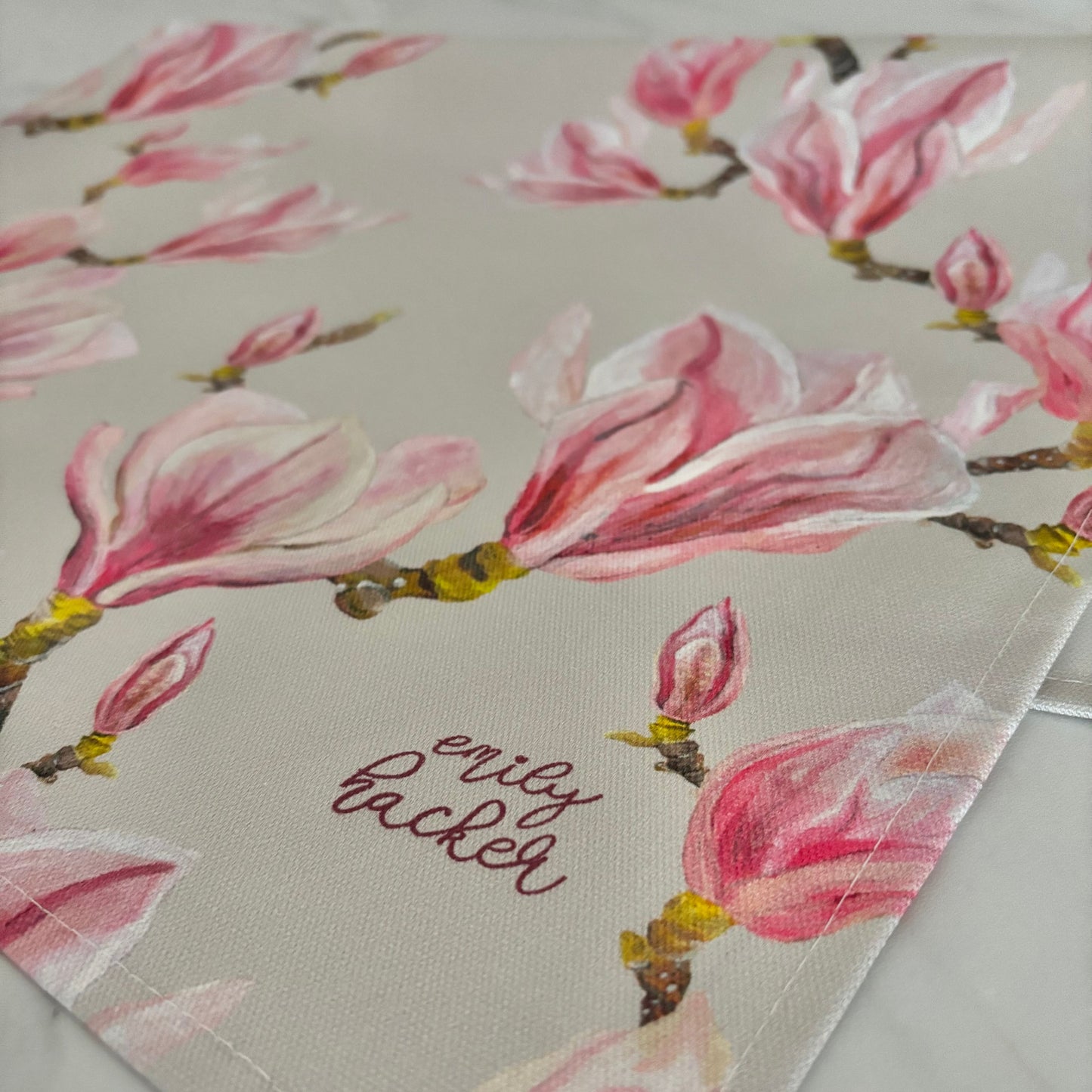 Light grey tea towel with pink magnolia blossom illustrations