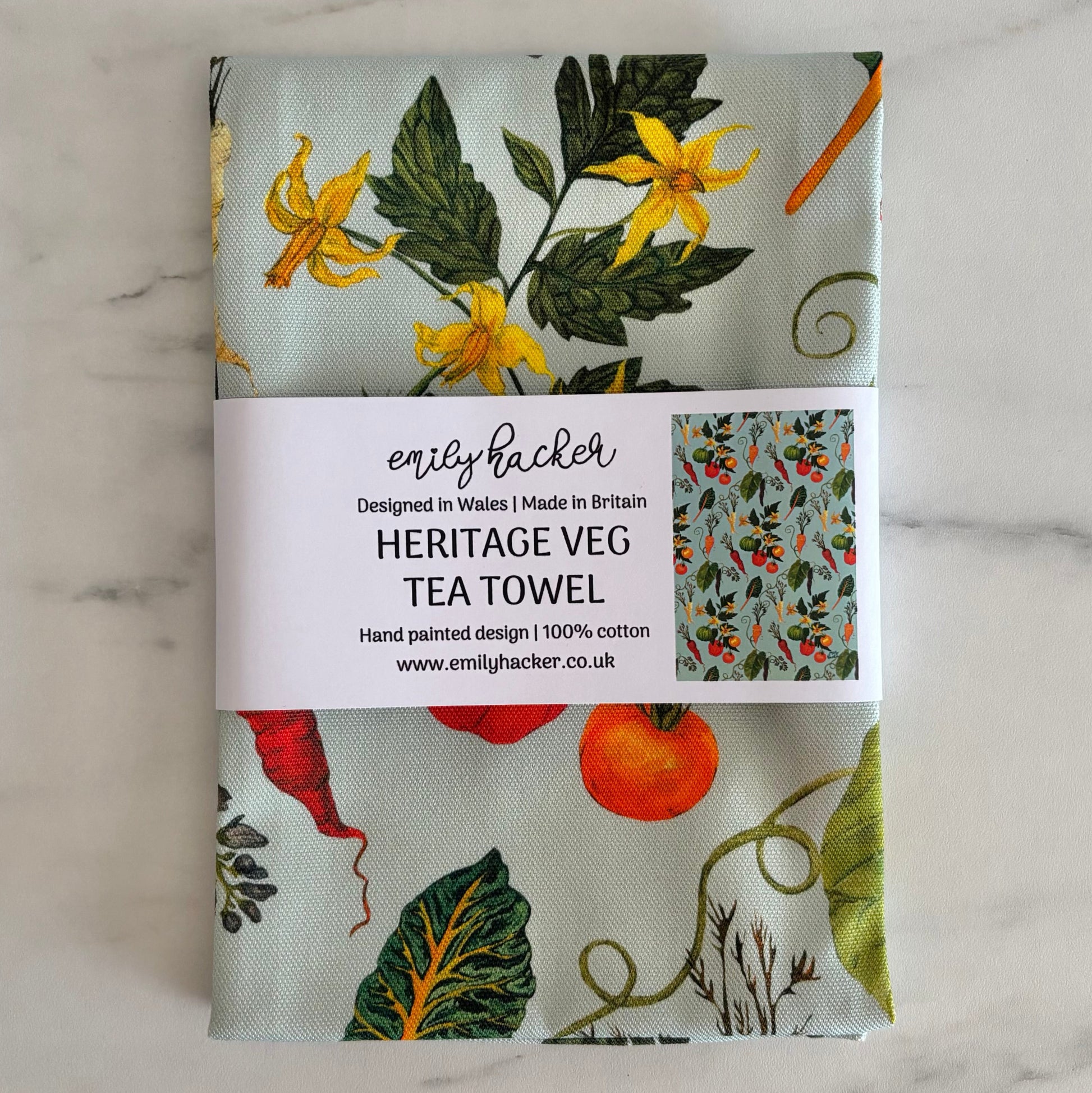 Hand painted heritage veg design on 100% cotton tea towel wrapped in a paper branded Emily Hacker belly band