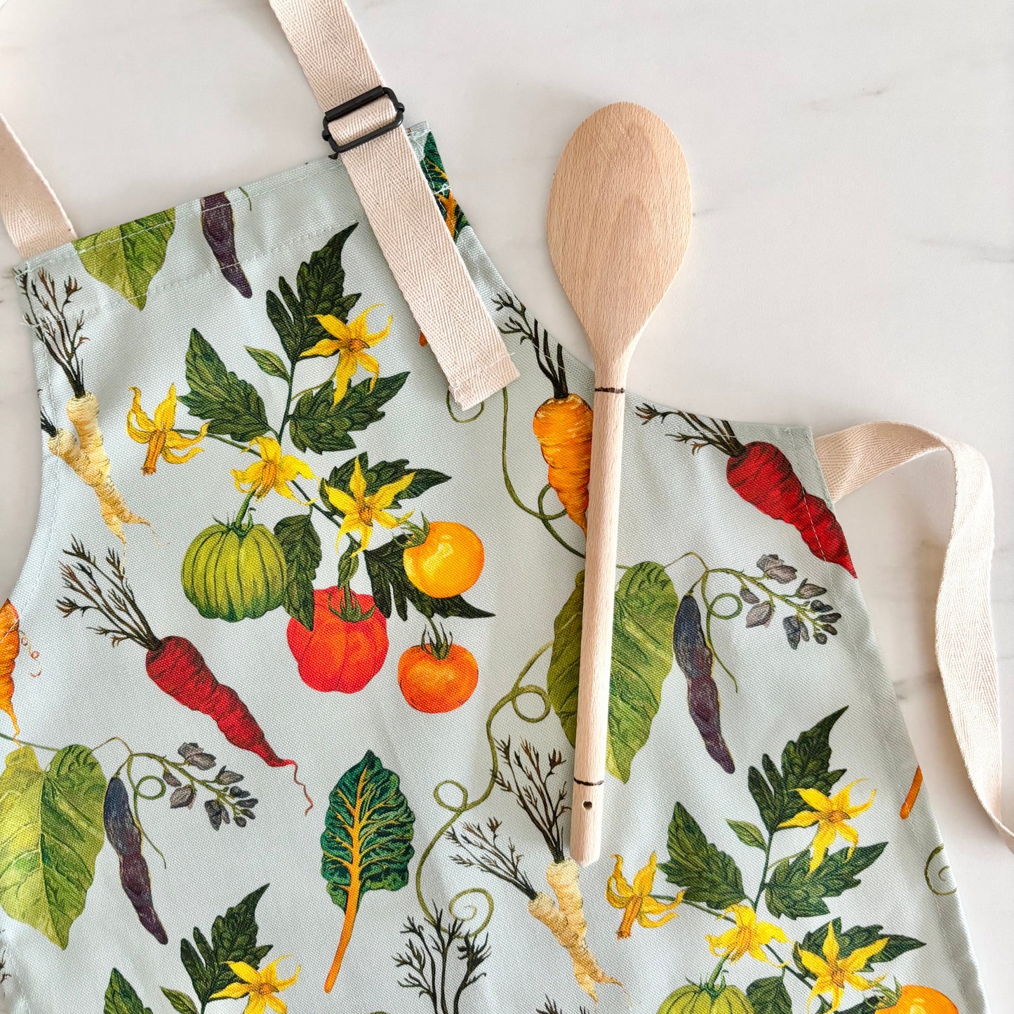 Cotton child’s apron with bright colourful veggie design