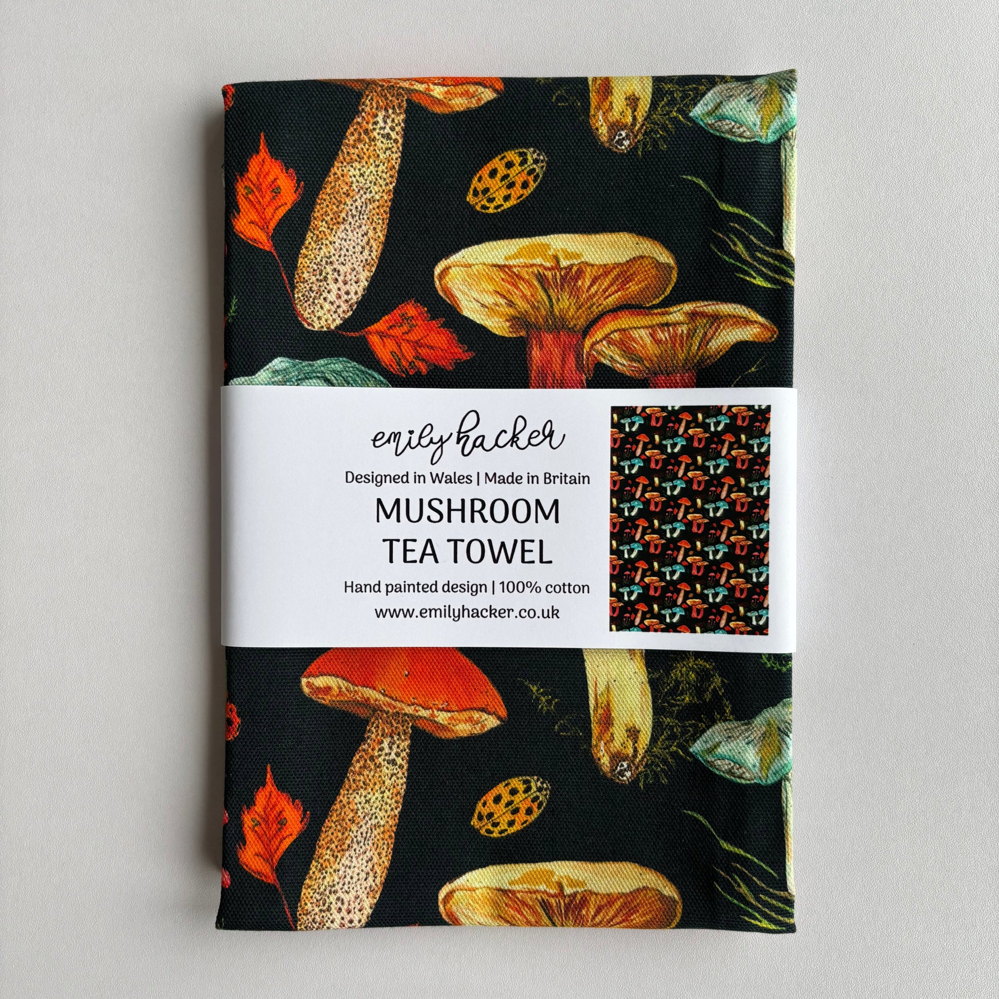 Dark blue Mushroom tea towel in branded paper belly band