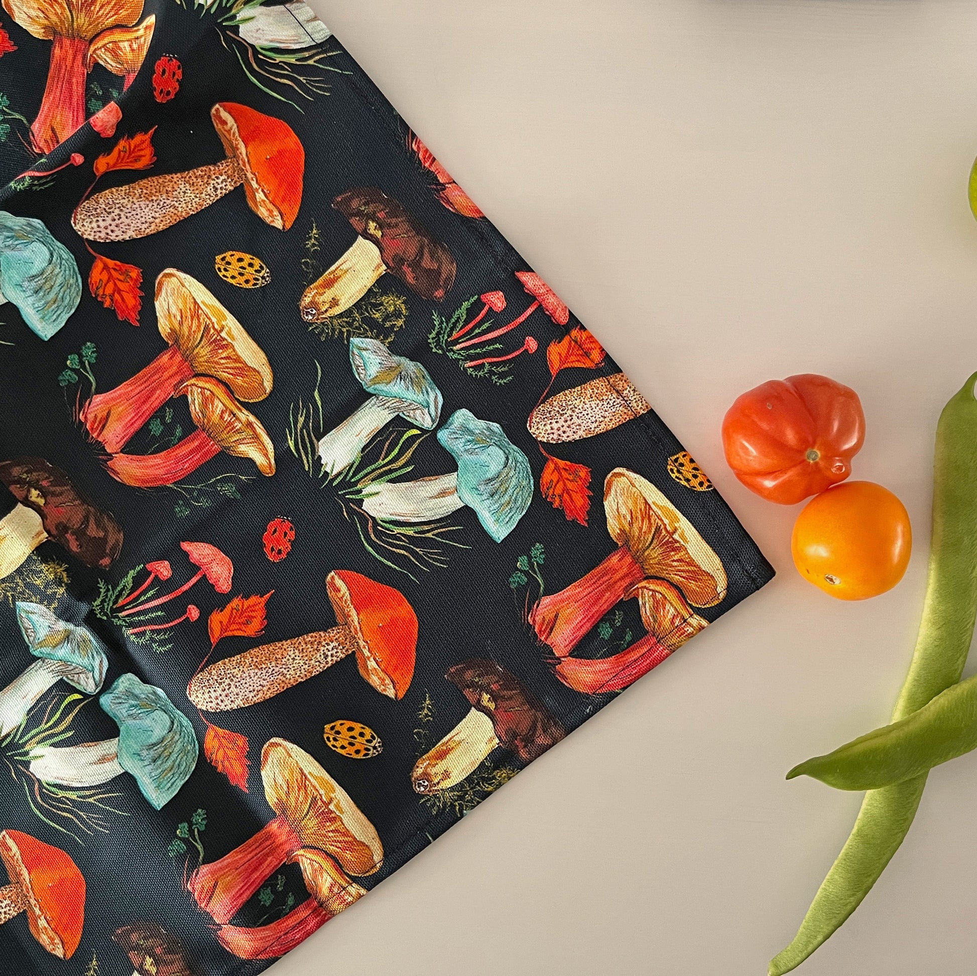 Woodland mushroom teatowel featuring fungi illustrations on a ink blue background