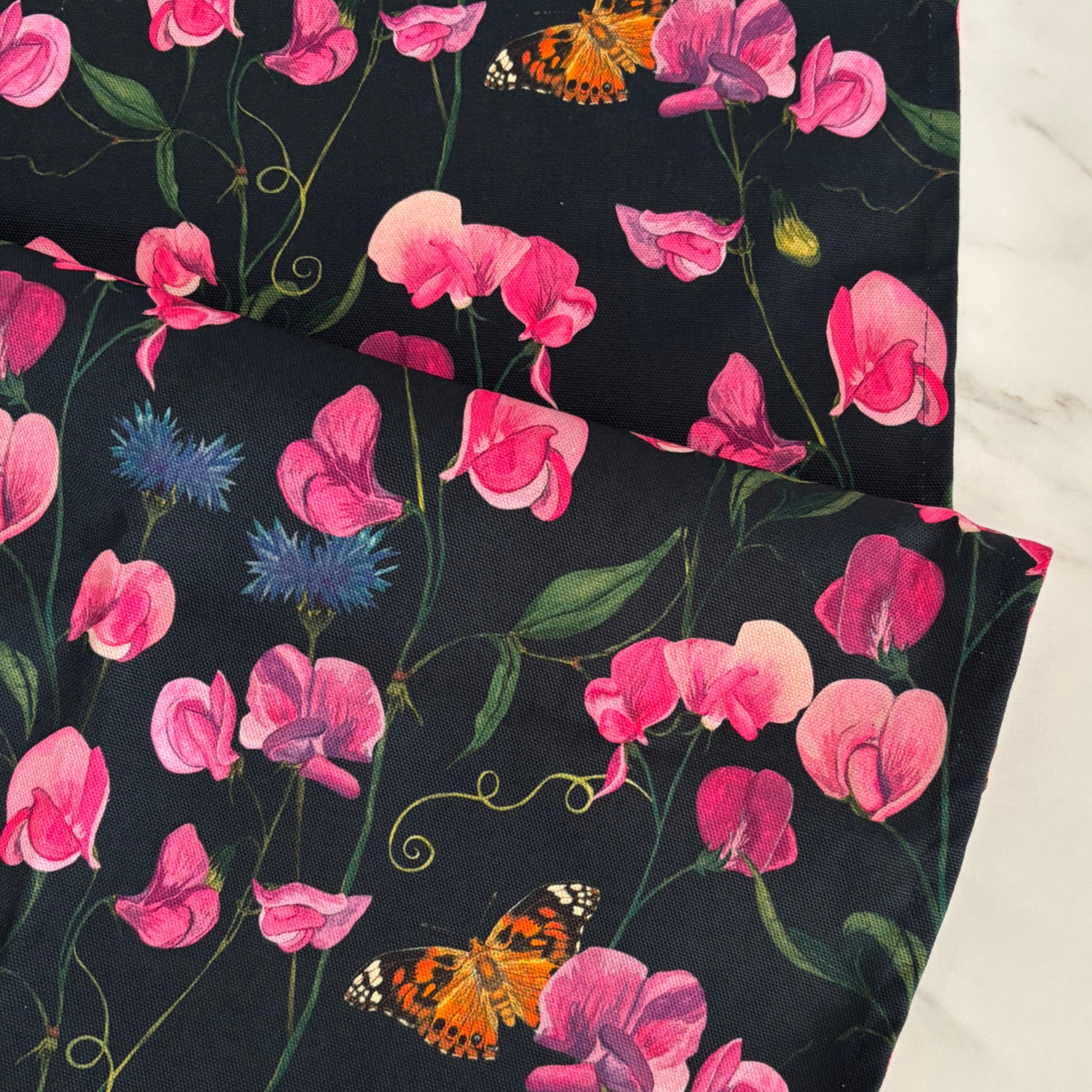 Hand painted sweet peas, cornflowers and painted lady butterfly on a dark blue background