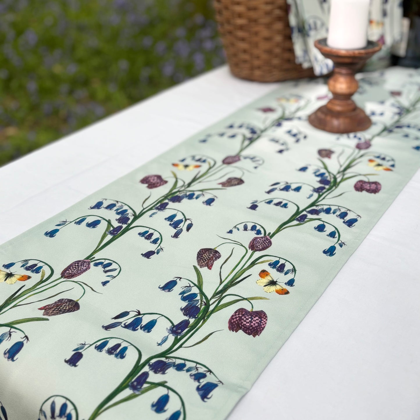 Blue nature inspired Table runner with floral bluebell design on a table outdoors