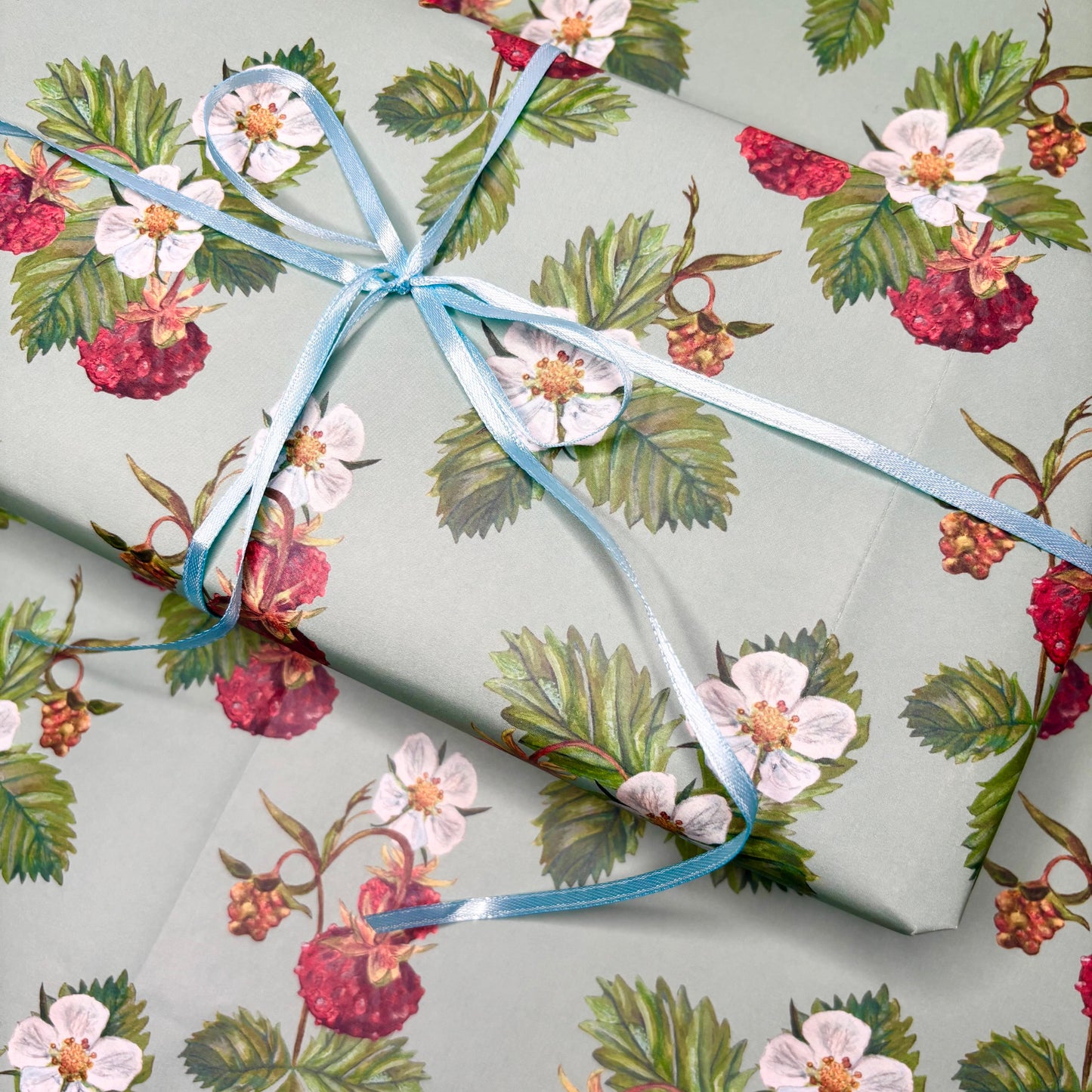 Strawberry Gift wrap in hand illustrated berry and floral patterned paper on a white background