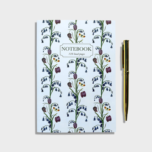 Native bluebell Notebook with floral wildflower design of English bluebells and snakehead fritillaries and a pen on a white background