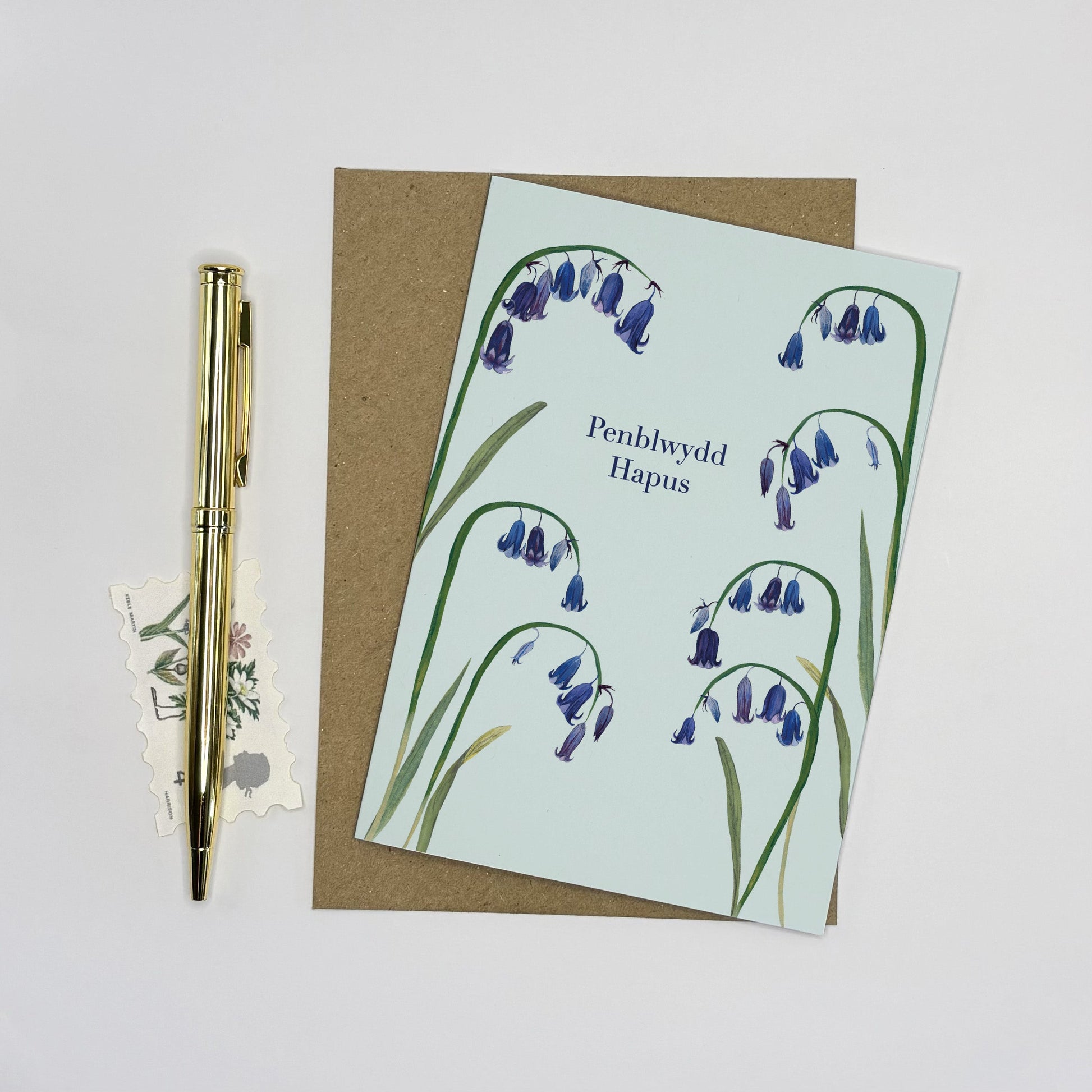 Native wildflower Greeting card with bluebell and snake head fritillary design and pen on a light grey background