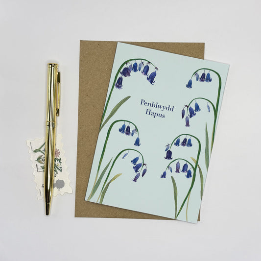 Native wildflower Greeting card with bluebell and snake head fritillary design and pen on a light grey background
