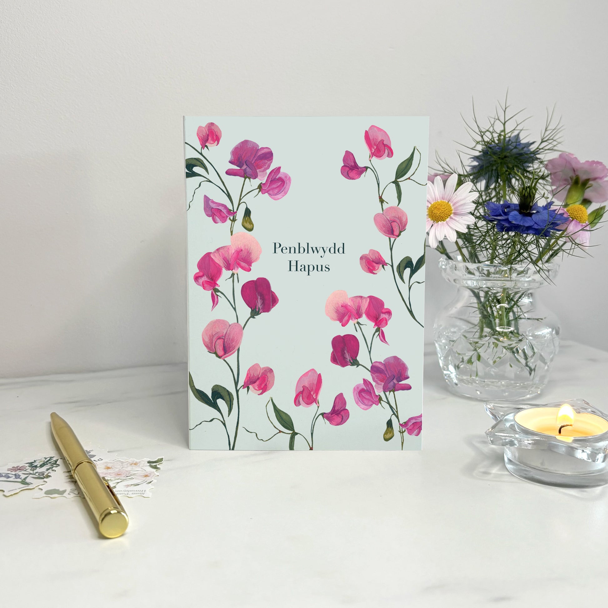 Sweet pea birthday Floral card with hand painted wildflower illustrations on a white surface
