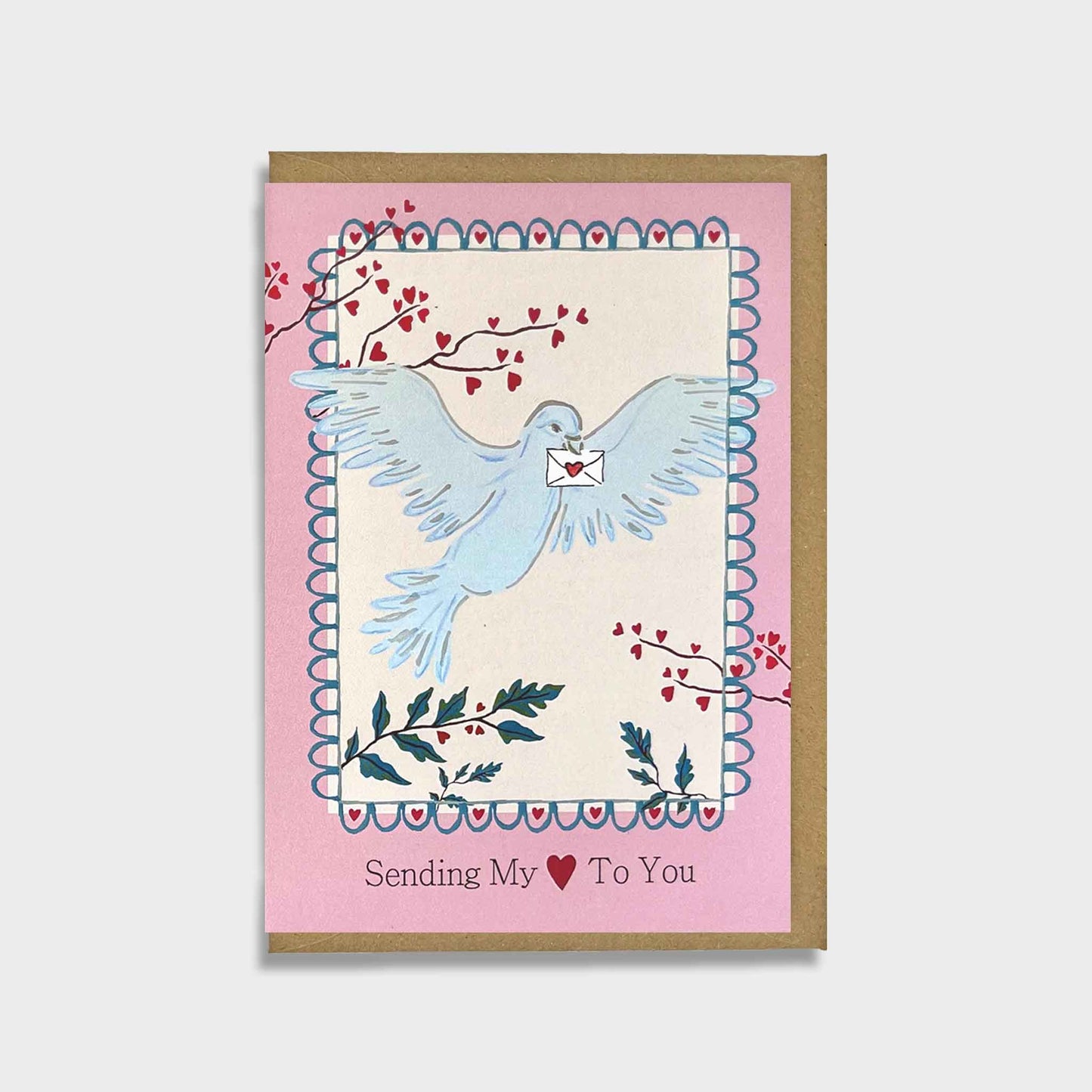 Greeting card with a blue dove holding an envelope, surrounded by branches with red hearts on a pink background.