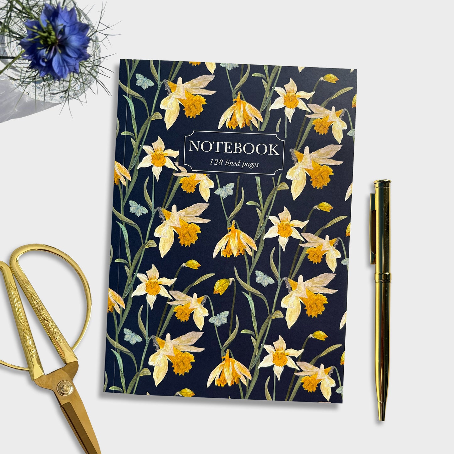 Hand illustrated Floral daffodil notebook with a pen and scissors on a white background