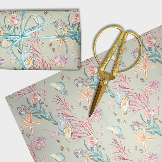 Seashell hand designed starfish patterned paper with gold scissors on a white background