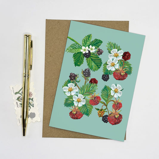 Strawberry Greeting card with hand painted wild berry and floral design on a light blue background, accompanied by a pen and stickers.