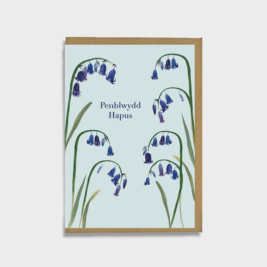 Spring flower Greeting card with bluebell illustrations and 'penblwydd hapus’ message on a light blue background