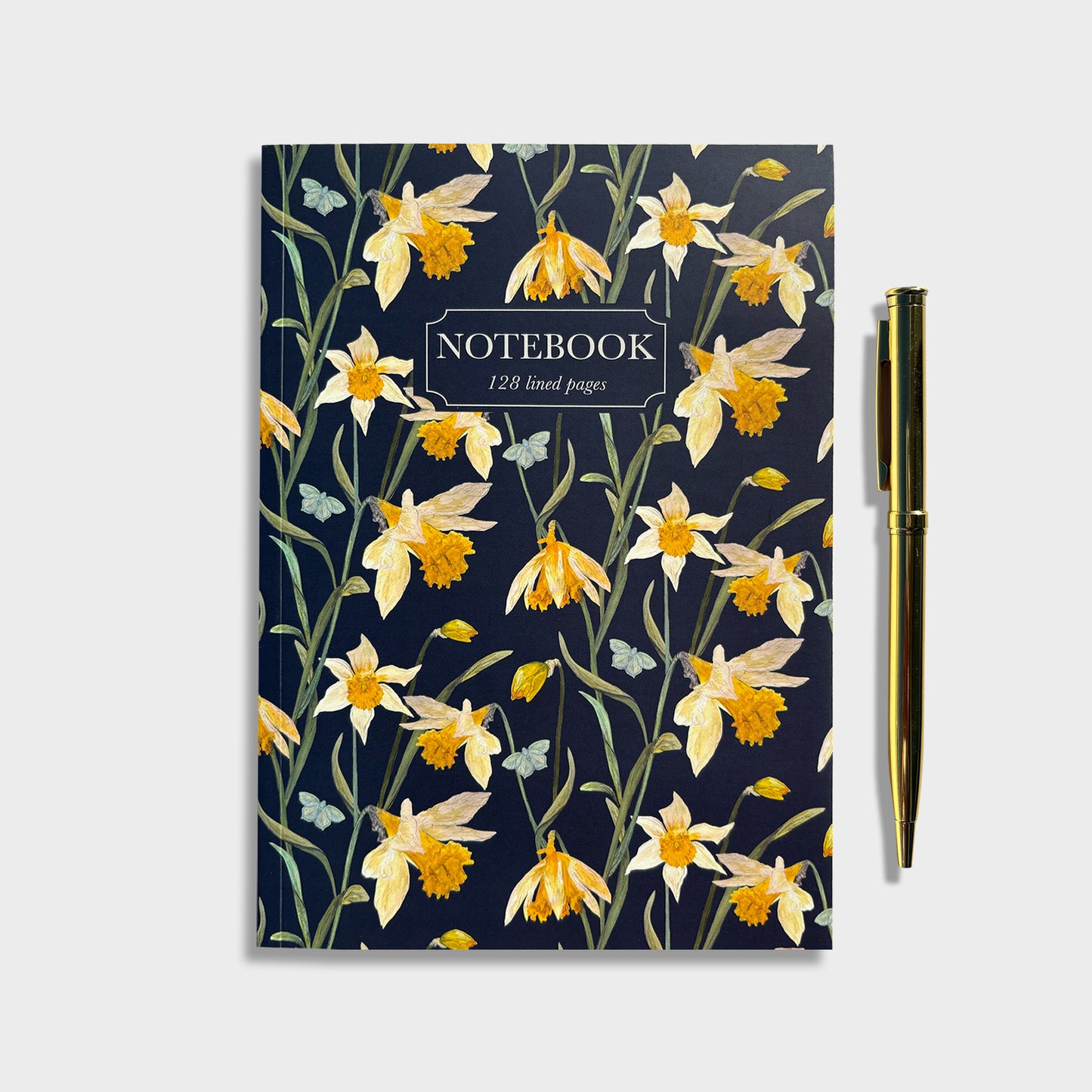 Native wildflower lined notebook with wild daffodil spring design on a dark blue background next to a gold pen