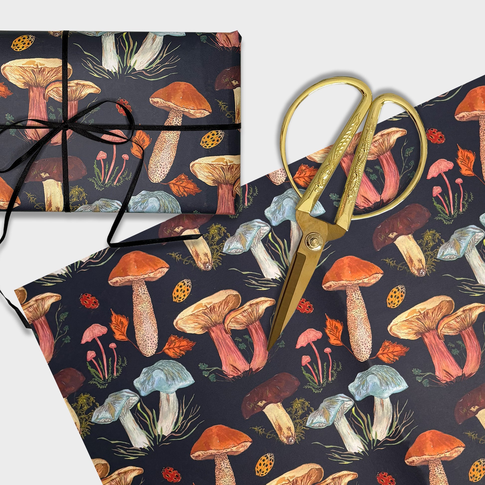Woodland Mushroom pattern illustrated  wrapping paper with gold scissors on a white background